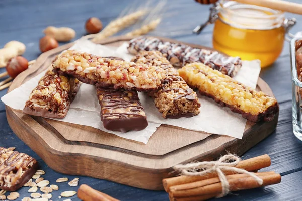 Wooden board with cereal energy bars — Stock Photo, Image