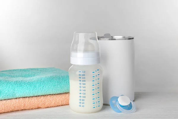 Composition with feeding bottle of baby milk formula on wooden table — Stock Photo, Image