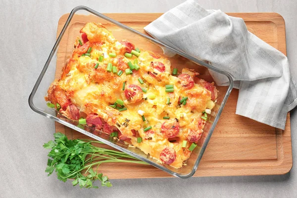 Delicious sausage casserole in baking dish on table — Stock Photo, Image