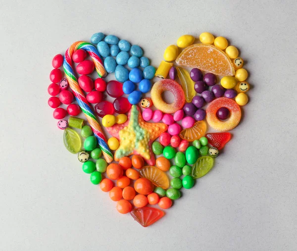 Bonbons colorés disposés comme coeur — Photo