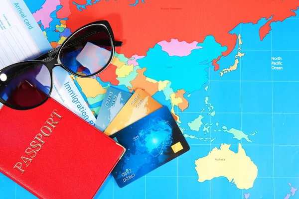 Composición con tarjetas de crédito y pasaporte en el fondo del mapa mundial —  Fotos de Stock