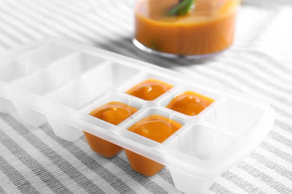 Container with baby food on table — Stock Photo, Image