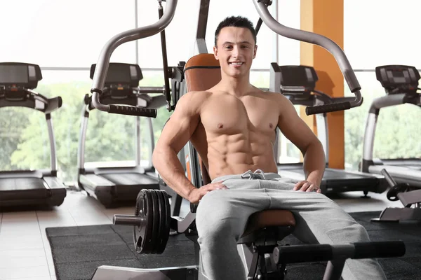 Jeune homme sportif s'entraînant en salle de gym — Photo