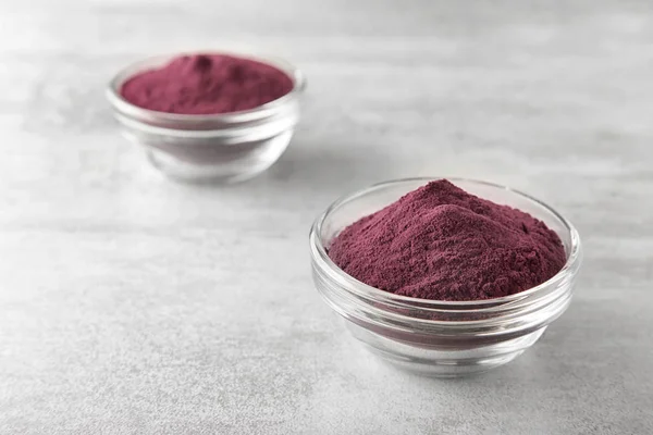 Bowls with acai powder on table — Stock Photo, Image