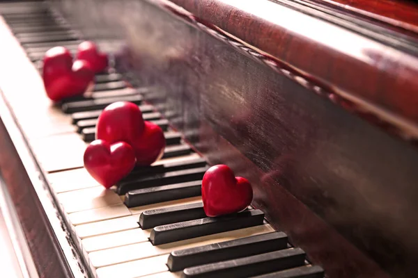 Red hearts on piano keys, closeup