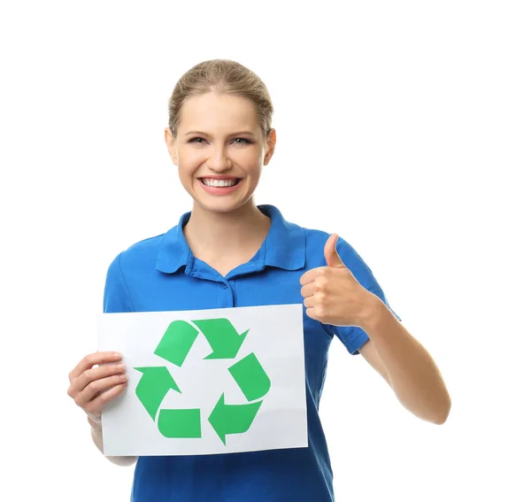 Young woman holding paper sheet with recycling symbol on white background — Stock Photo, Image