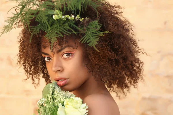Vackra unga afroamerikanska kvinnan med örter mot tegelvägg — Stockfoto