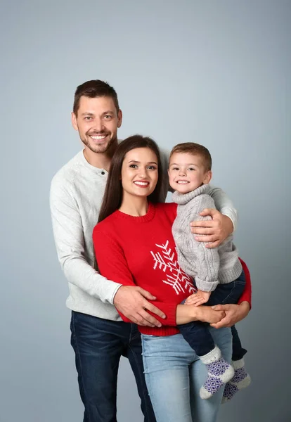 Happy couple with son on light background — Stock Photo, Image