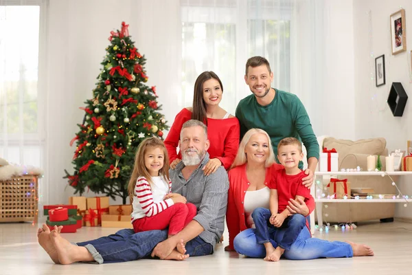 Happy family in room decorated for Christmas — Stock Photo, Image