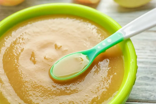 Plastic bowl with baby food — Stock Photo, Image