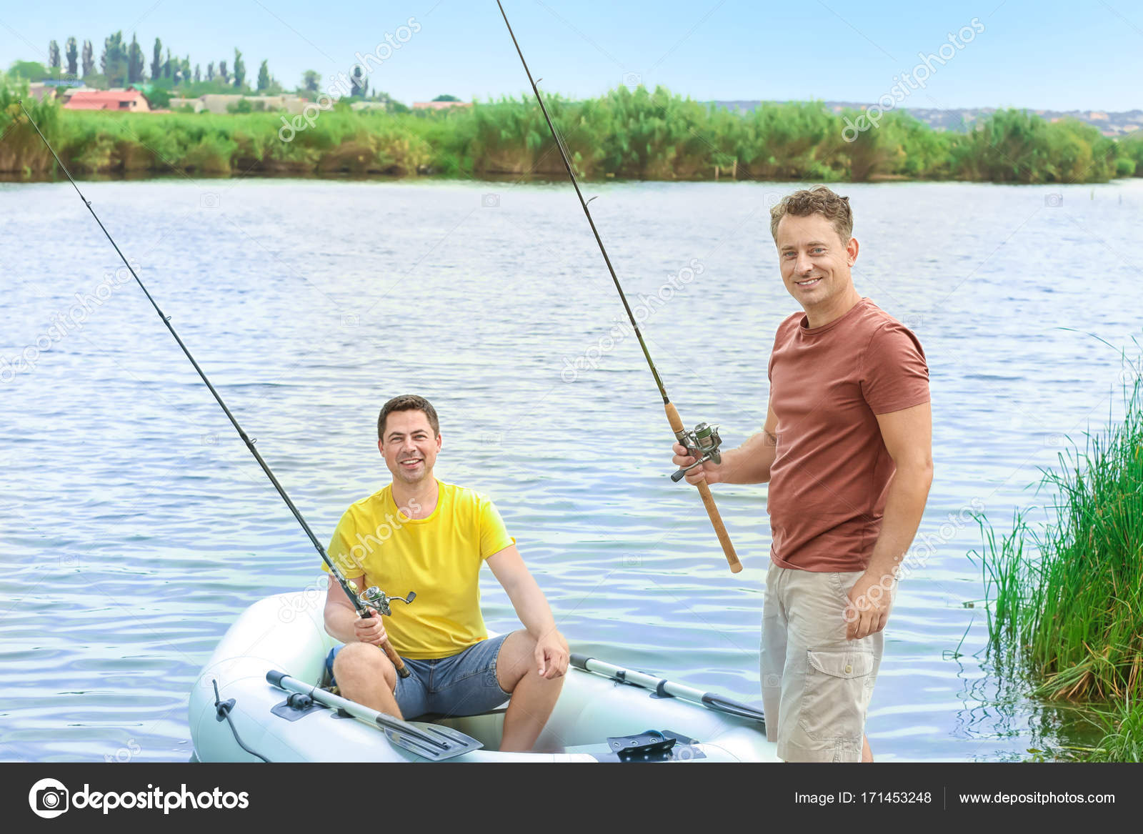 Two men fishing from inflatable boat on river Stock Photo by ©belchonock  171453248