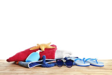 Plaj havlusu ve beyaz arka plan karşı masada yaz aksesuarları