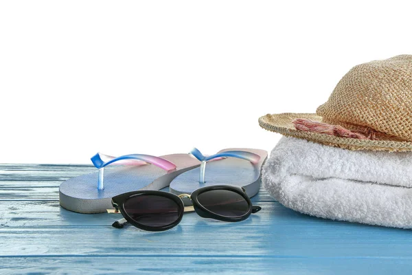 Beach towel and summer accessories on table against white background — Stock Photo, Image