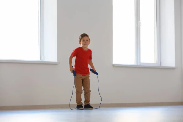 Adorable boy skipping rope indoors — Stock Photo, Image