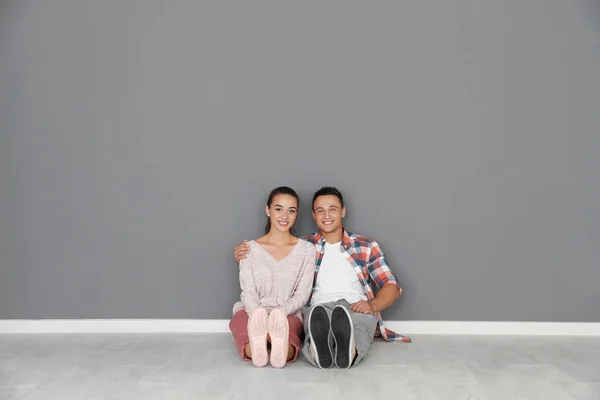 Pareja joven y feliz sentada en el piso de su nuevo apartamento. Casa movimiento concepto — Foto de Stock