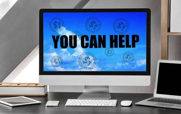 Workplace with computer and text YOU CAN HELP on screen. Charity and volunteering concept — Stockfoto