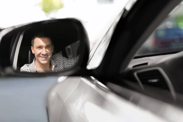 Reflejo del conductor en el espejo retrovisor de un coche —  Fotos de Stock