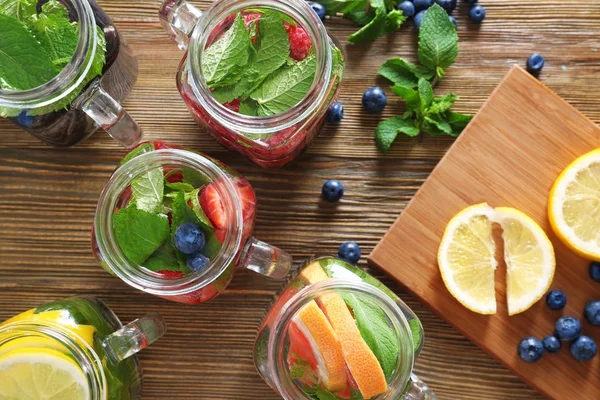 Mason jars of infused water with fruits — Stock Photo, Image