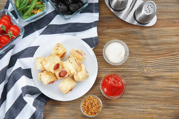 Tasty sausage rolls and sauces — Stock Photo, Image