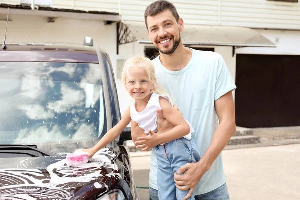 Mannen med lilla dotter tvätt bil utomhus — Stockfoto