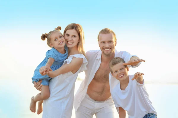 Happy family on sea beach at resort — Stock Photo, Image