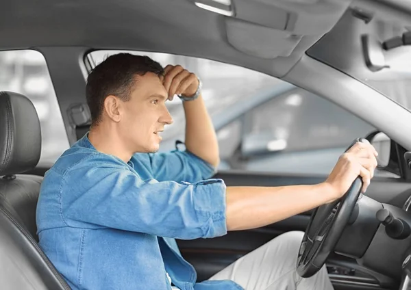 Knappe man in een auto. — Stockfoto