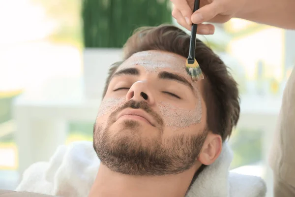 Beautician applying scrub onto face — Stock Photo, Image