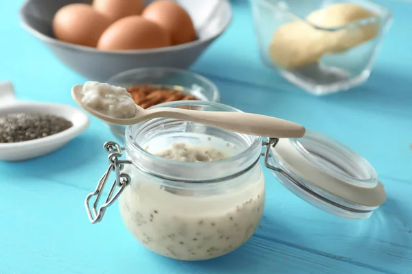 Glass jar and spoon with chia seed pudding — Stock Photo, Image