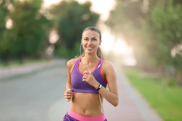 Young sporty woman running in park — Stock Photo, Image