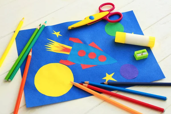 Child's applique of rocket on wooden table — Stock Photo, Image