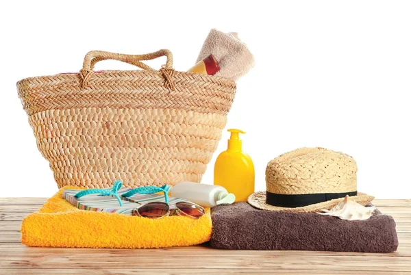 Beach towels and summer accessories on table against white background — Stock Photo, Image