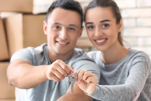 Feliz joven pareja sosteniendo las llaves de su nuevo apartamento —  Fotos de Stock