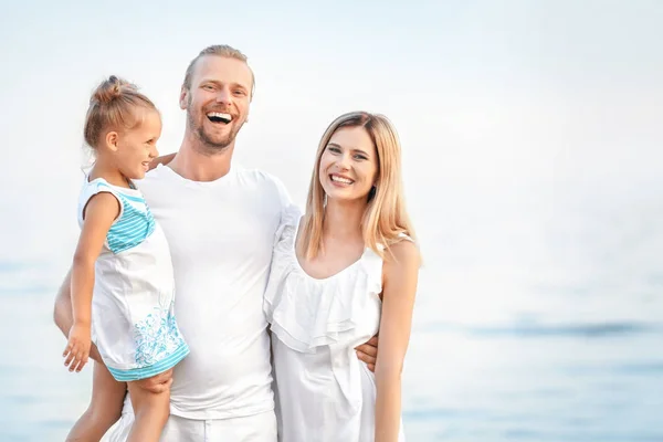 Happy family on sea beach at resort — Stock Photo, Image