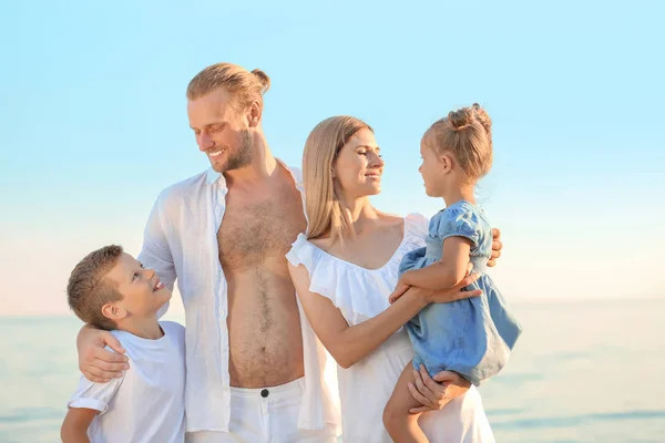 Happy family on sea beach at resort — Stock Photo, Image