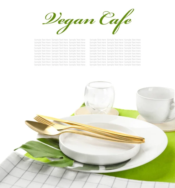 Table setting and text VEGAN CAFE on white background — Stock Photo, Image