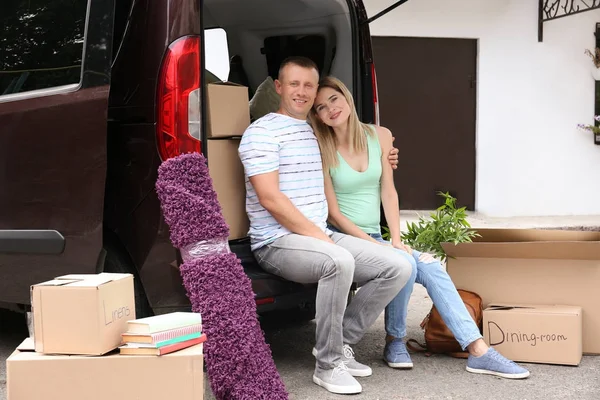 Pareja feliz con cajas móviles cerca del coche al aire libre — Foto de Stock