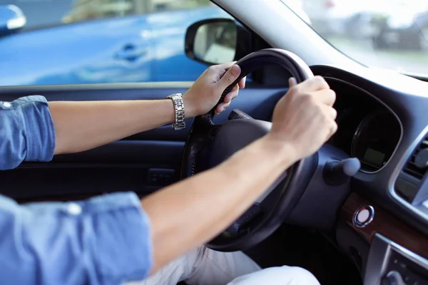 Male hands on steering wheel of a car — Stock Photo, Image