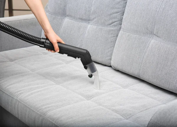 Woman cleaning couch