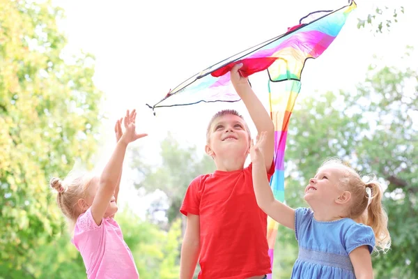 Cute little children with colorful kite outdoors — Stock Photo, Image