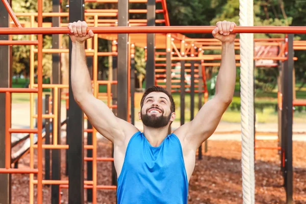 Bonito jovem se exercitando no parque — Fotografia de Stock