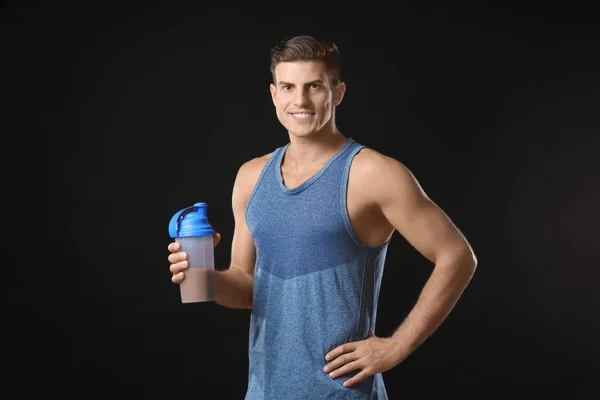 Young man holding bottle with protein shake — Stock Photo, Image