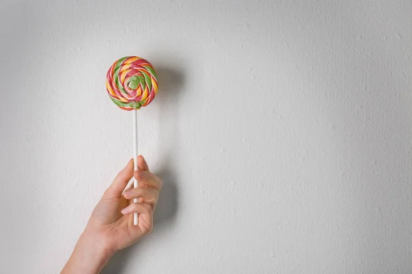 Woman holding tasty lollipop — Stock Photo, Image