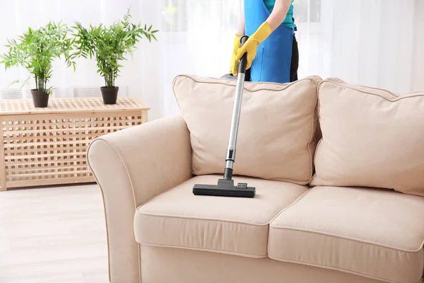 Woman cleaning couch