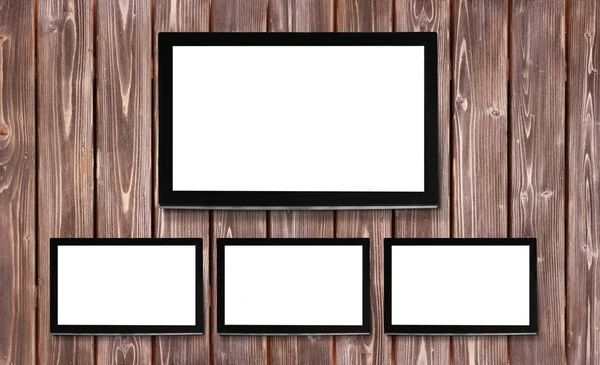 Сучасні телевізійні екрани на дерев'яному фоні стіни — стокове фото