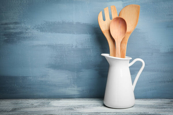 Wooden kitchen utensils in jug