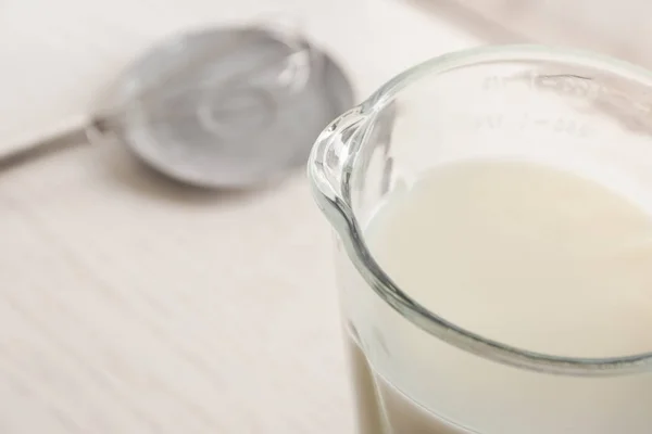 Glass jug with yogurt for making pudding — Stock Photo, Image