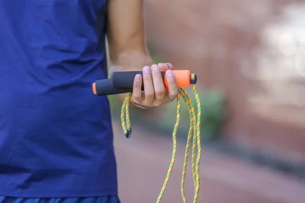 Young man holding jumping rope