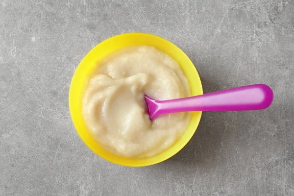 Plastic bowl with baby food — Stock Photo, Image