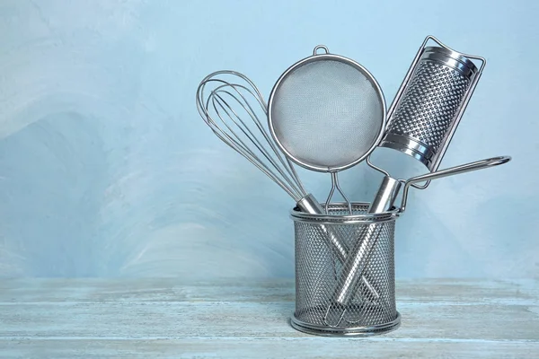 Kitchen utensils in deep fry basket on table — Stock Photo, Image