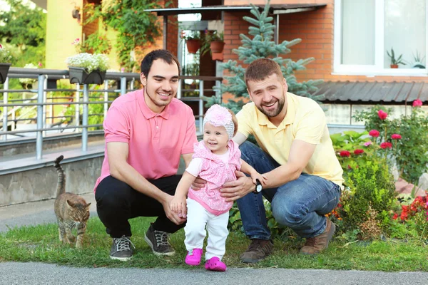 Male gay couple with adopted baby girl, outdoors — Stock Photo, Image